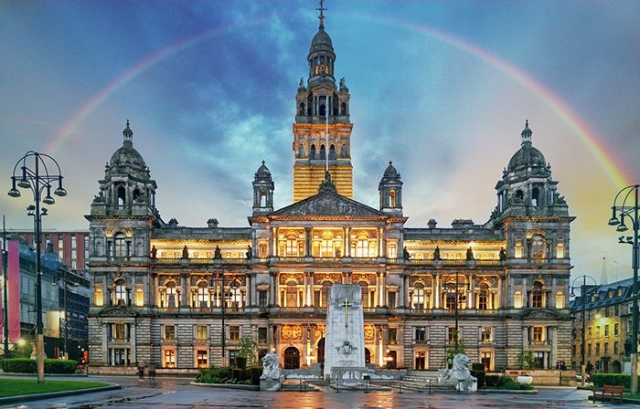 Glasgow City Chambers at dusk with a rainbow overhead